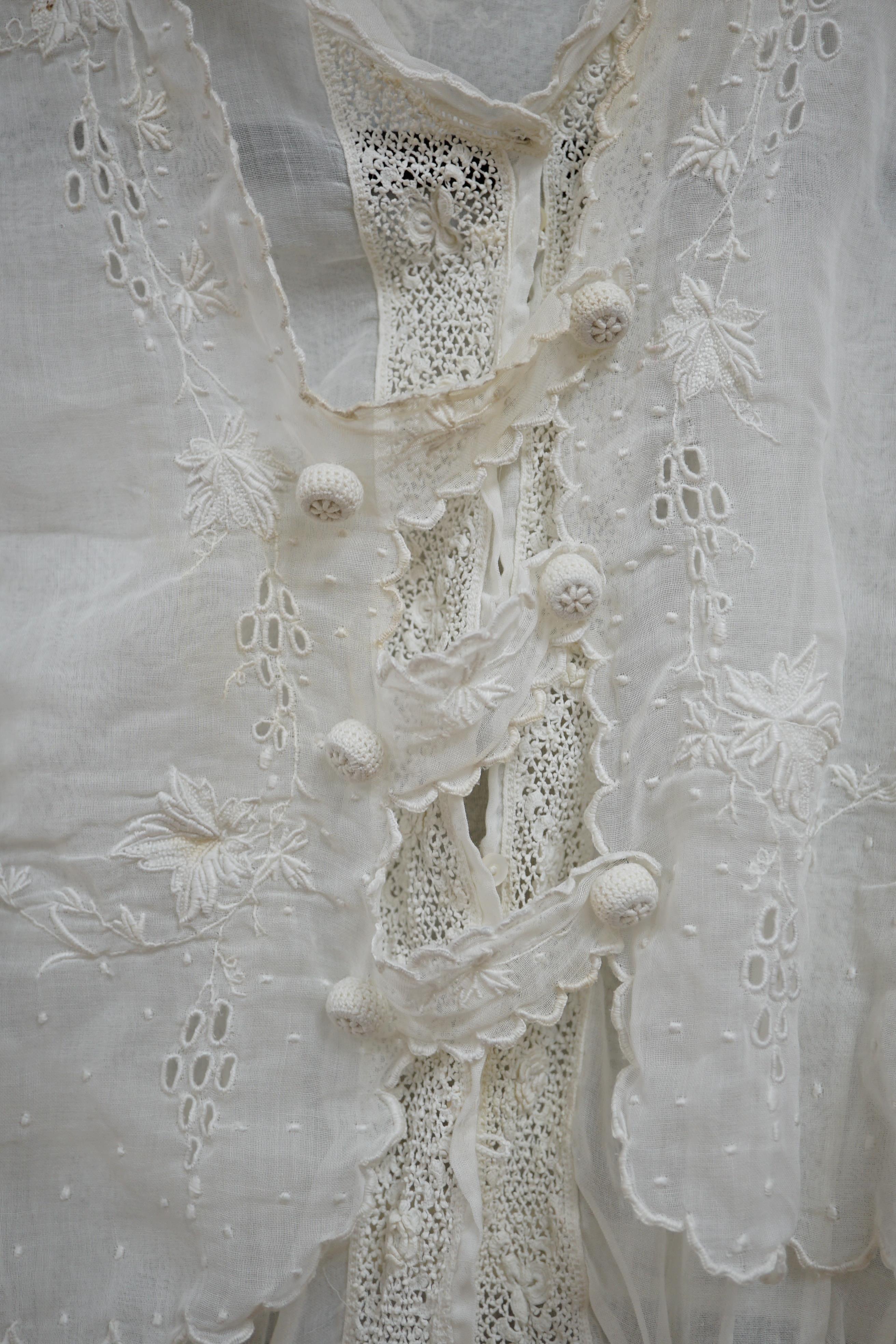 An early Edwardian fine lawn ladies hand made and embroidered crochet dress, embroidered with a white worked skirt, cuffs and lower waist and Irish crochet bodice insertions, with novelty detailing of a faux jacket front